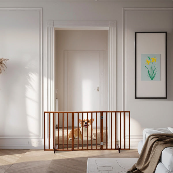Brown wooden dog gate installed in doorway with small dog sitting behind it in bright living room