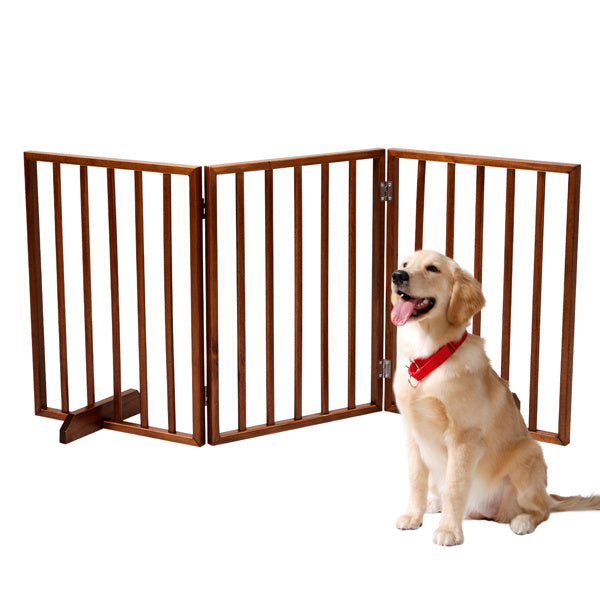 Brown wooden dog gate with three panels next to a sitting golden retriever dog wearing a red collar