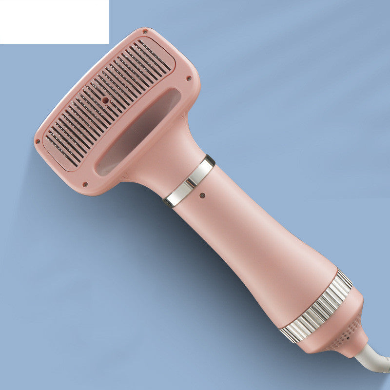Pink pet grooming blow dryer with brush attachment for dog grooming on blue background